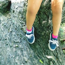 Low section of woman standing on tiled floor
