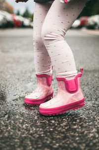 Low section of woman standing on street