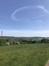 Scenic view of field against blue sky