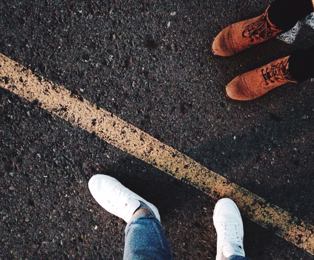 low section, person, shoe, standing, personal perspective, high angle view, lifestyles, human foot, street, footwear, men, leisure activity, directly above, unrecognizable person, road, asphalt, outdoors