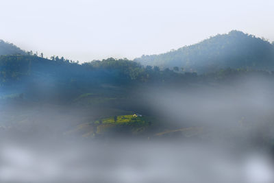 Scenic view of mountains in foggy weather