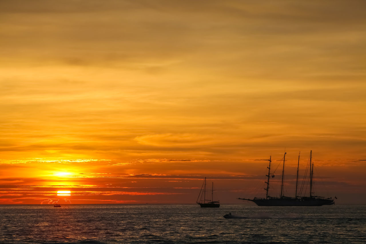 SILHOUETTE OF BOATS IN SEA AGAINST SUNSET SKY