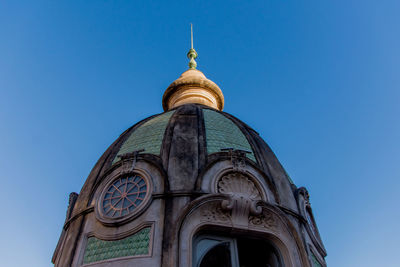 Low angle view of a building against blue sky