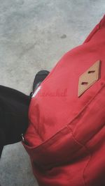 Low section of person wearing red shoes