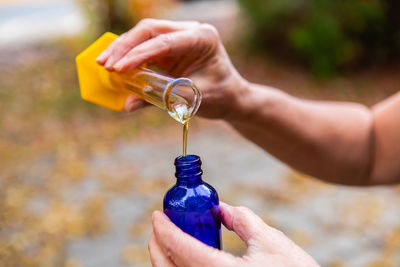 Close-up of hand pouring water