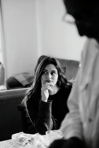 Young woman sitting at home