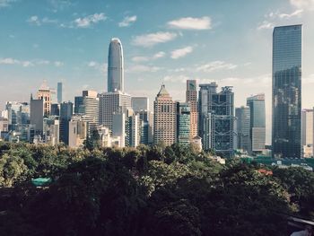 Skyscrapers against cloudy sky