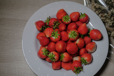 High angle view of strawberries in bowl on table