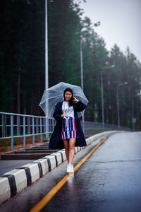 Portrait of a beautiful young woman in rain