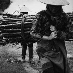 Women carrying firewood on field