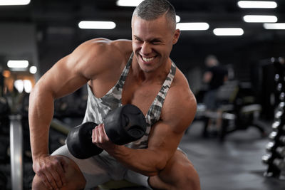 Portrait of man exercising at gym