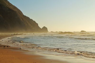 Scenic view of sea against clear sky during sunset