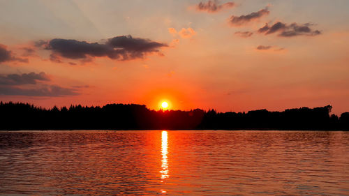 Scenic view of lake against romantic sky at sunset