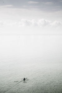 High angle view of man sculling in sea