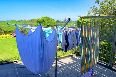 Clothes drying against blue sky