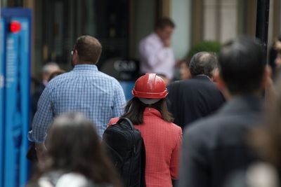 Rear view of people standing against blurred background