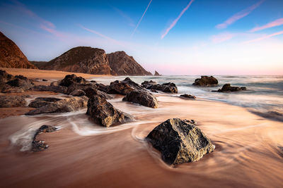 Rocks on the adraga beach -praia da adraga sintra, portugal