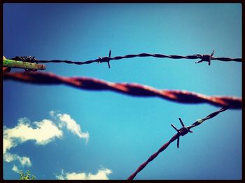 Low angle view of barbed wire fence