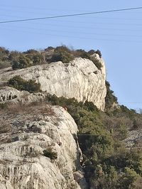 Rock formations on landscape against sky