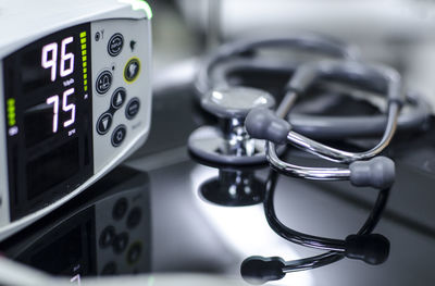 Close-up of stethoscope and monitoring equipment on table