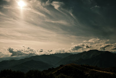 Scenic view of silhouette mountains against sky at sunset