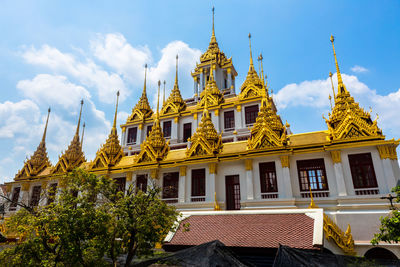 Low angle view of yellow building against sky
