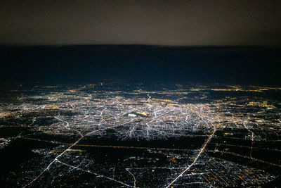 High angle view of illuminated buildings in city at night