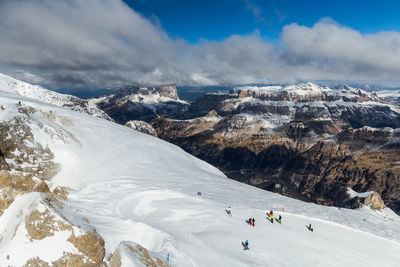 High angle view of people on snowcapped mountains against sky