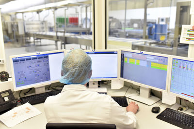 Worker in control center of an industrial bakery