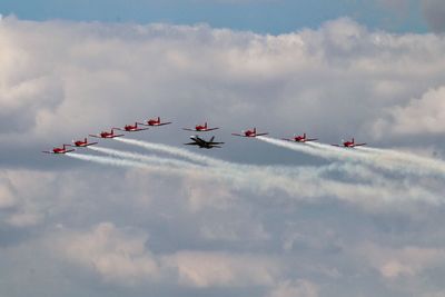 Low angle view of fighter planes flying against sky