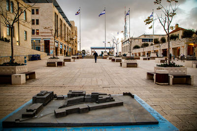 Street amidst buildings in city against sky