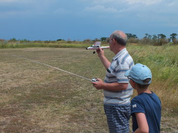 Rear view of man standing on field