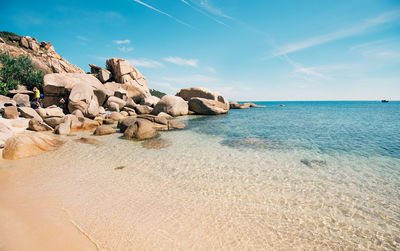 Rocks on beach against sky