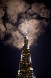 Low angle view of illuminated skyscrapers against sky at night