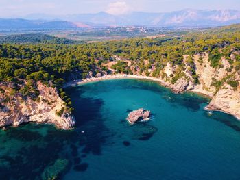 Aerial view of sea and rocks against sky