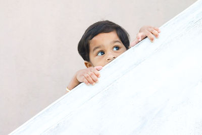 Low angle view of girl looking away by railing