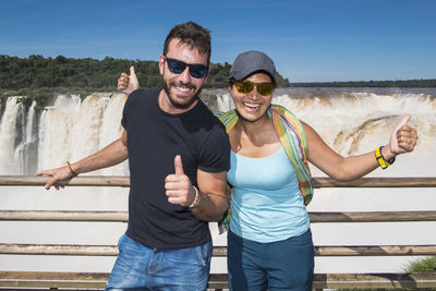 Couple posing at the devil's throat waterfall at iguazu falls