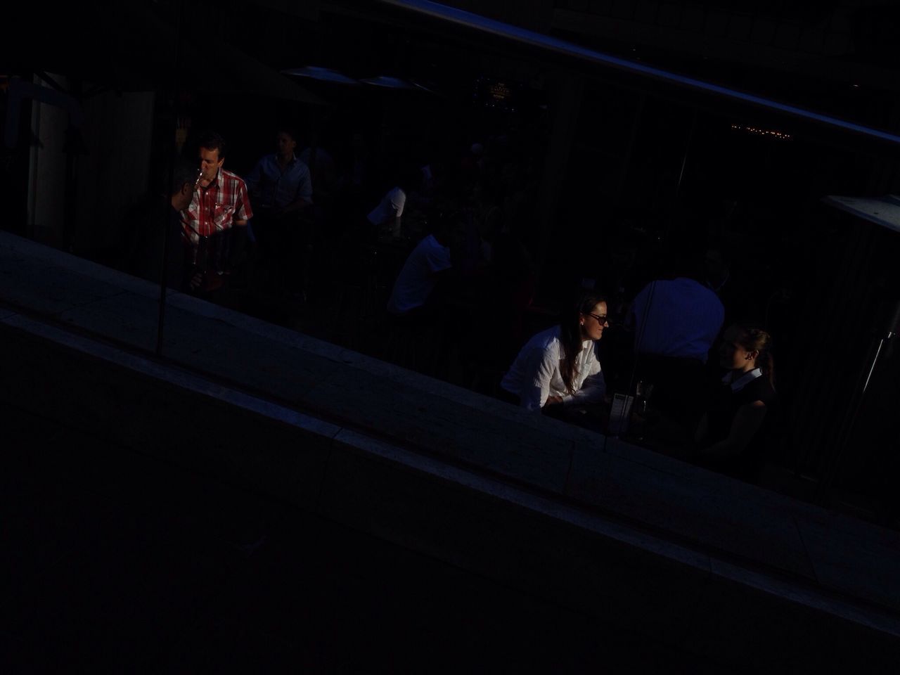 night, illuminated, dark, indoors, men, lifestyles, person, leisure activity, togetherness, sitting, standing, full length, silhouette, street, light - natural phenomenon, group of people, walking, medium group of people