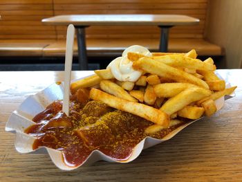 Close-up of meat and fries on table