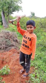 Portrait of boy standing on field