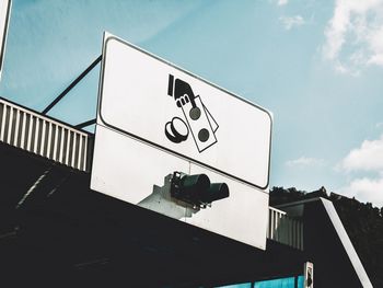 Low angle view of road sign against sky