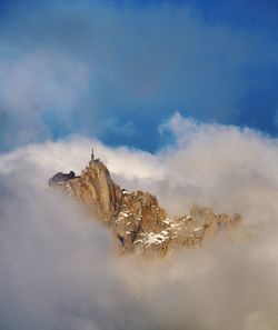 Castle on mountain against sky