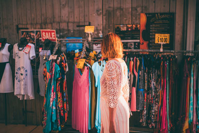 Rear view of woman standing at store