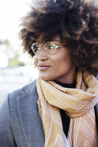 Close-up of woman with curly hair looking away