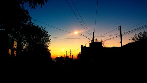 Low angle view of electricity pylon against sky