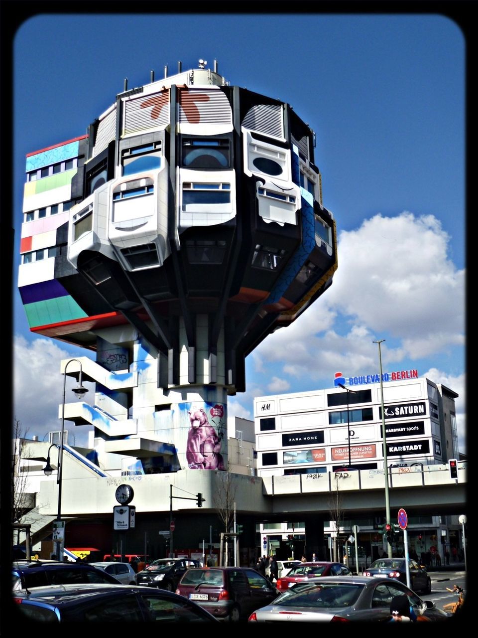 transfer print, transportation, land vehicle, car, mode of transport, building exterior, architecture, auto post production filter, built structure, low angle view, sky, street, city, stationary, day, incidental people, blue, road, building, city life