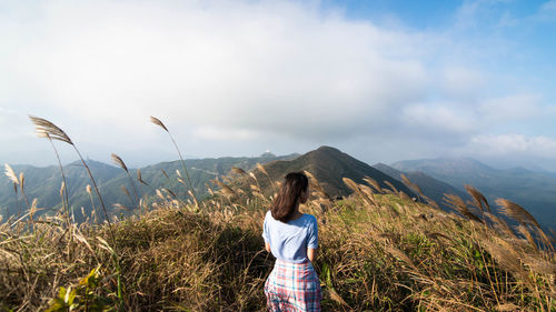 Woman overlooking countryside landscape