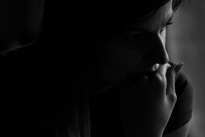 Close-up of thoughtful woman in darkroom