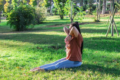 Woman is doing yoga asana outside in a park. concept of balancing and healthy lifestyle.