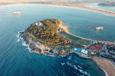 An ancient castle on a peninsula on the coast of the ocean. a castle made of split trees